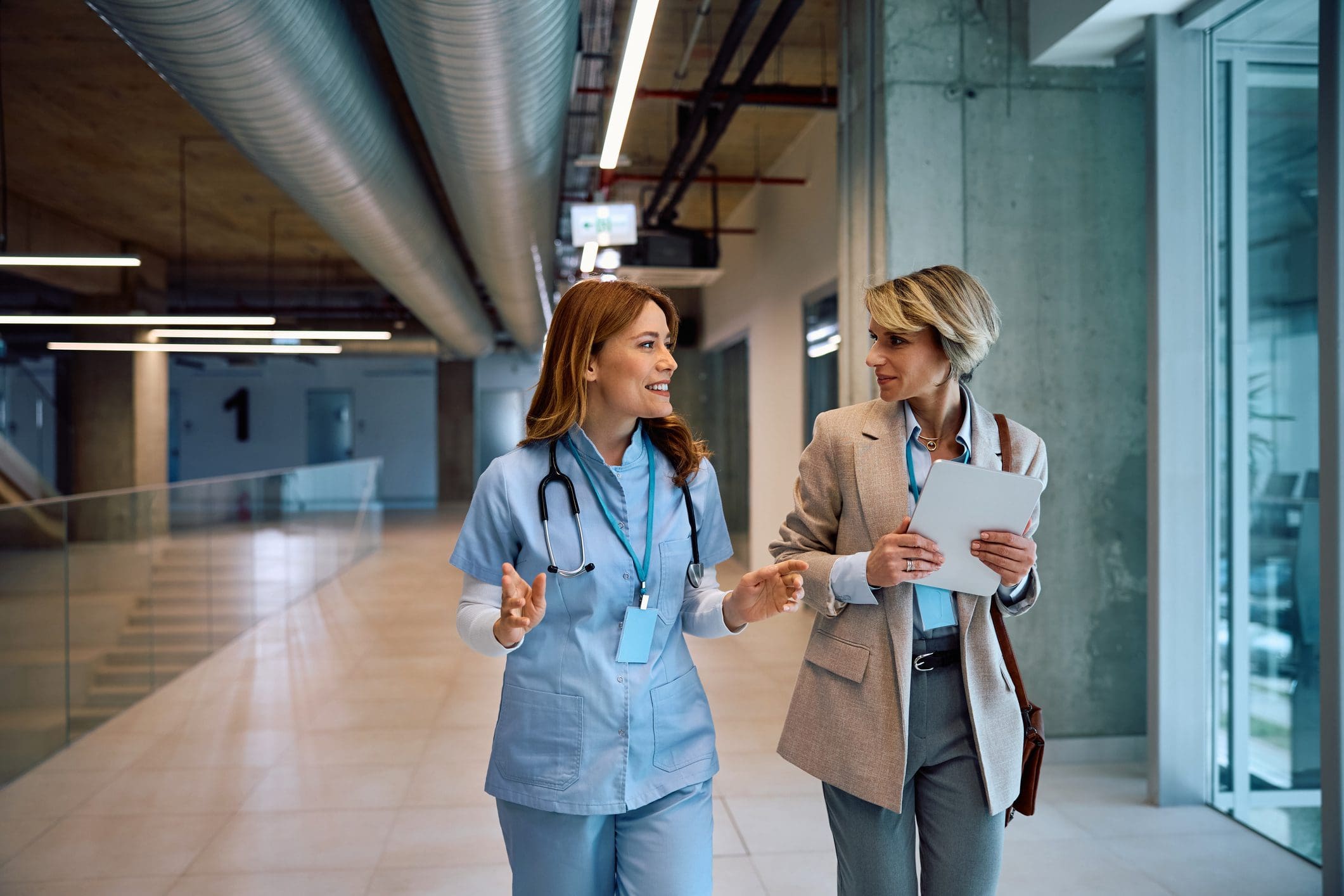 Two colleagues in hospital corridor
