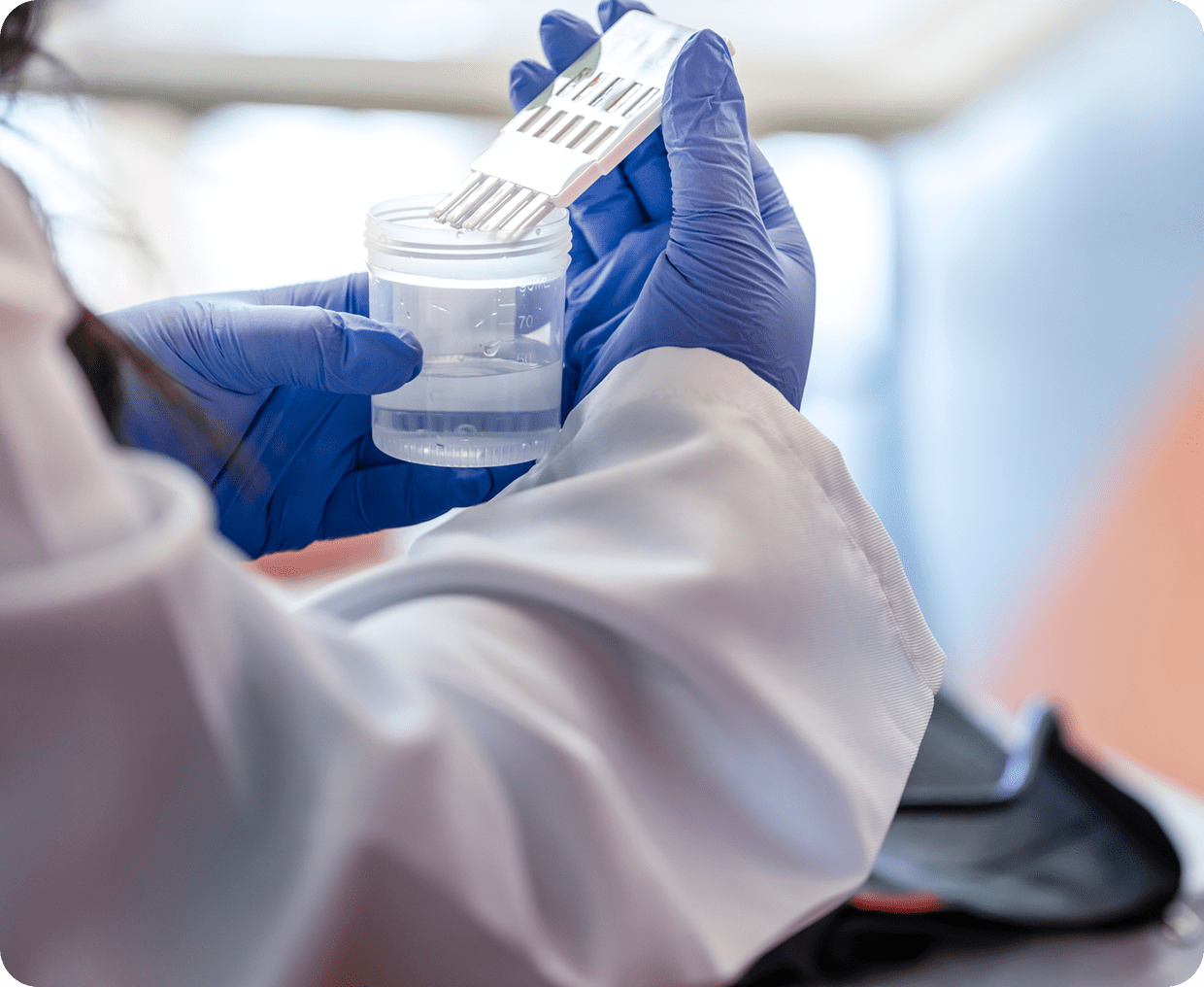 Scientist handling lab equipment with gloves