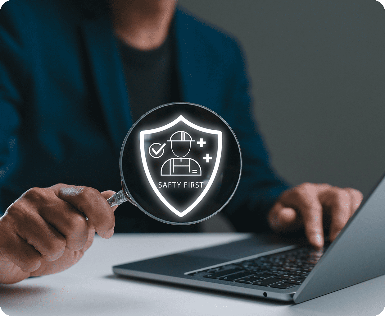 Person holding safety symbol with laptop