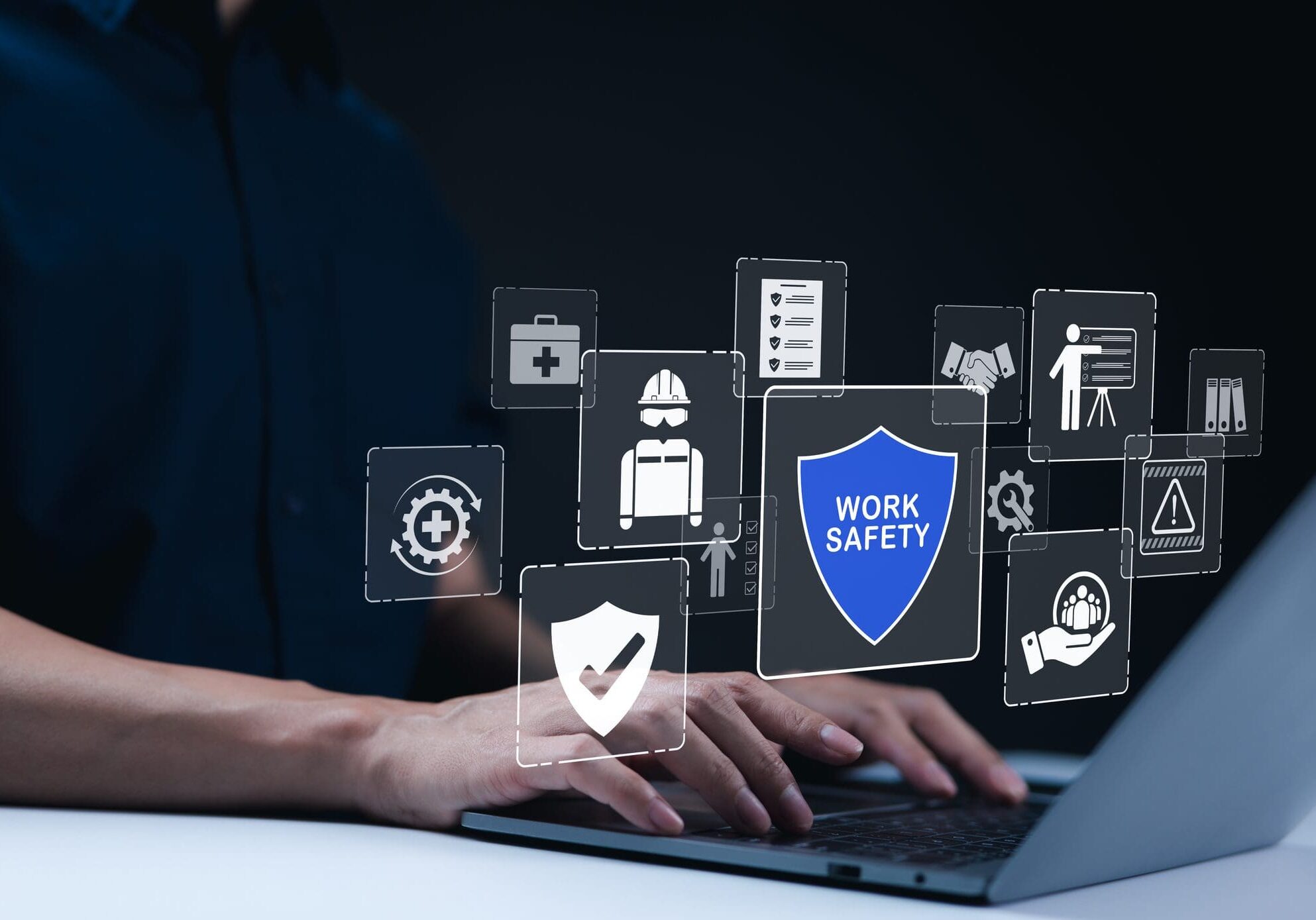 Person typing, work safety icons displayed above.