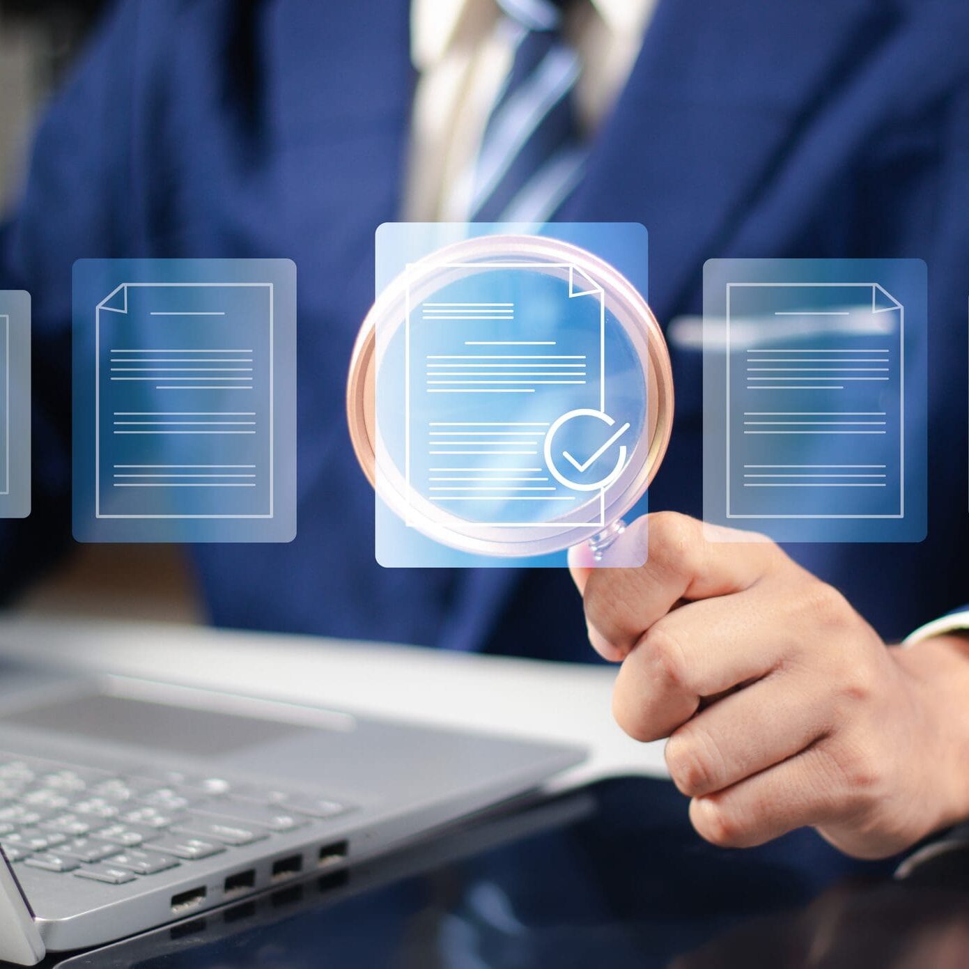 Businessperson analyzing digital documents on laptop screen.