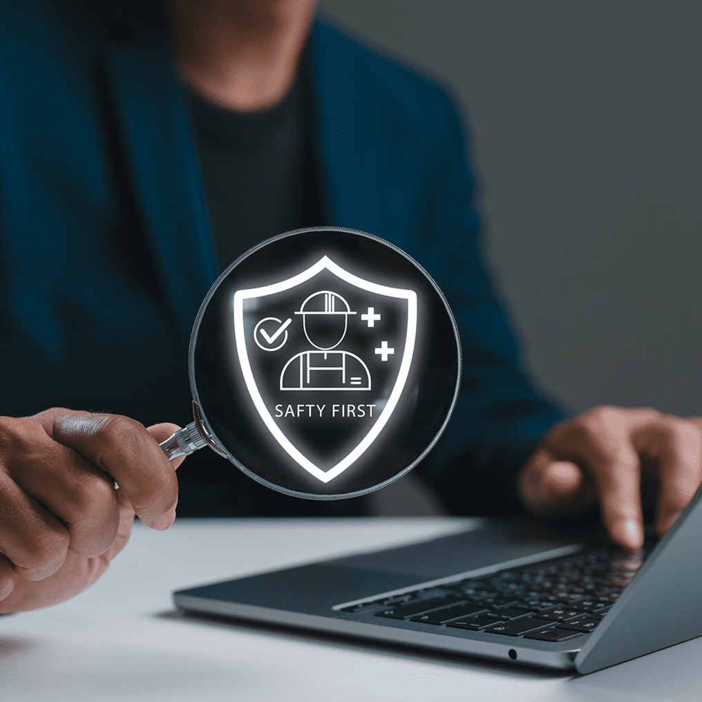 Person holding safety symbol with laptop
